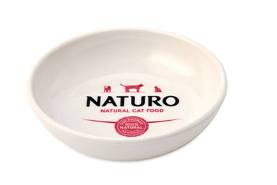 A white ceramic cat bowl with the brand 'Naturo' printed on the bottom.