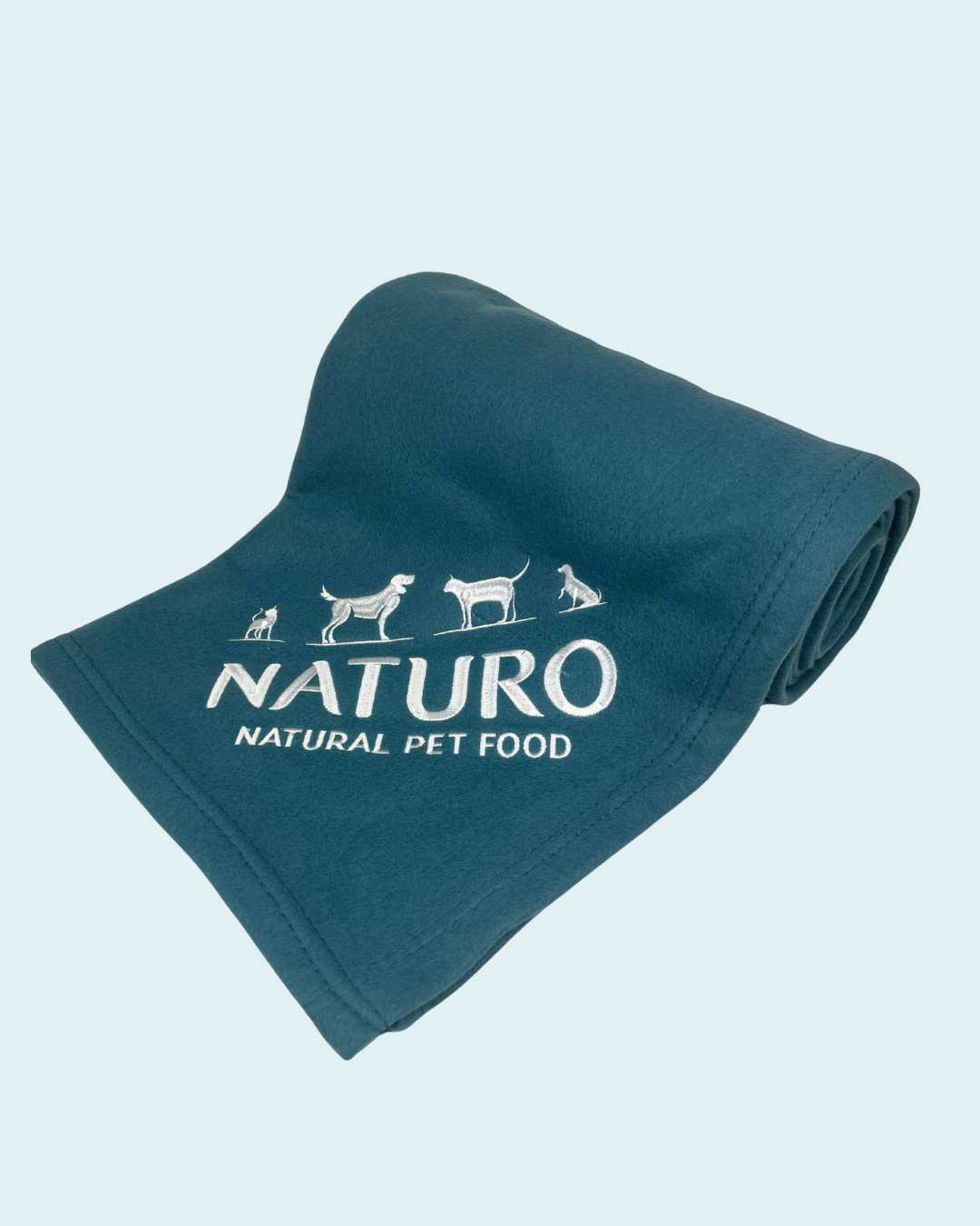 Teal blanket with Naturo Natural Pet Food logo on a light blue background