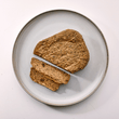 Naturo dog food tray on white plate in pale background sliced on plate