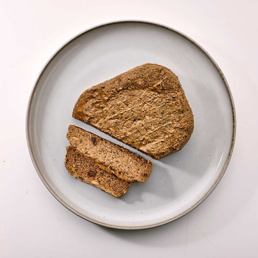 Naturo dog food tray on white plate in pale background sliced on plate