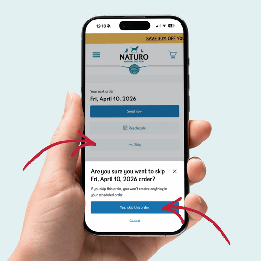 Hand holding a smartphone displaying the Naturo app with an order confirmation screen.