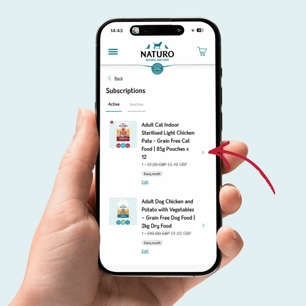 Hand holding a smartphone displaying the Naturo app on a light blue background