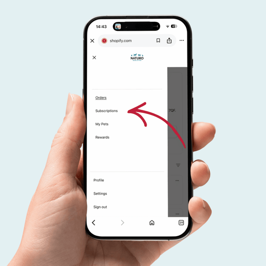 Hand holding a smartphone displaying the Naturello app with a red arrow pointing to the 'Subscriptions' section.